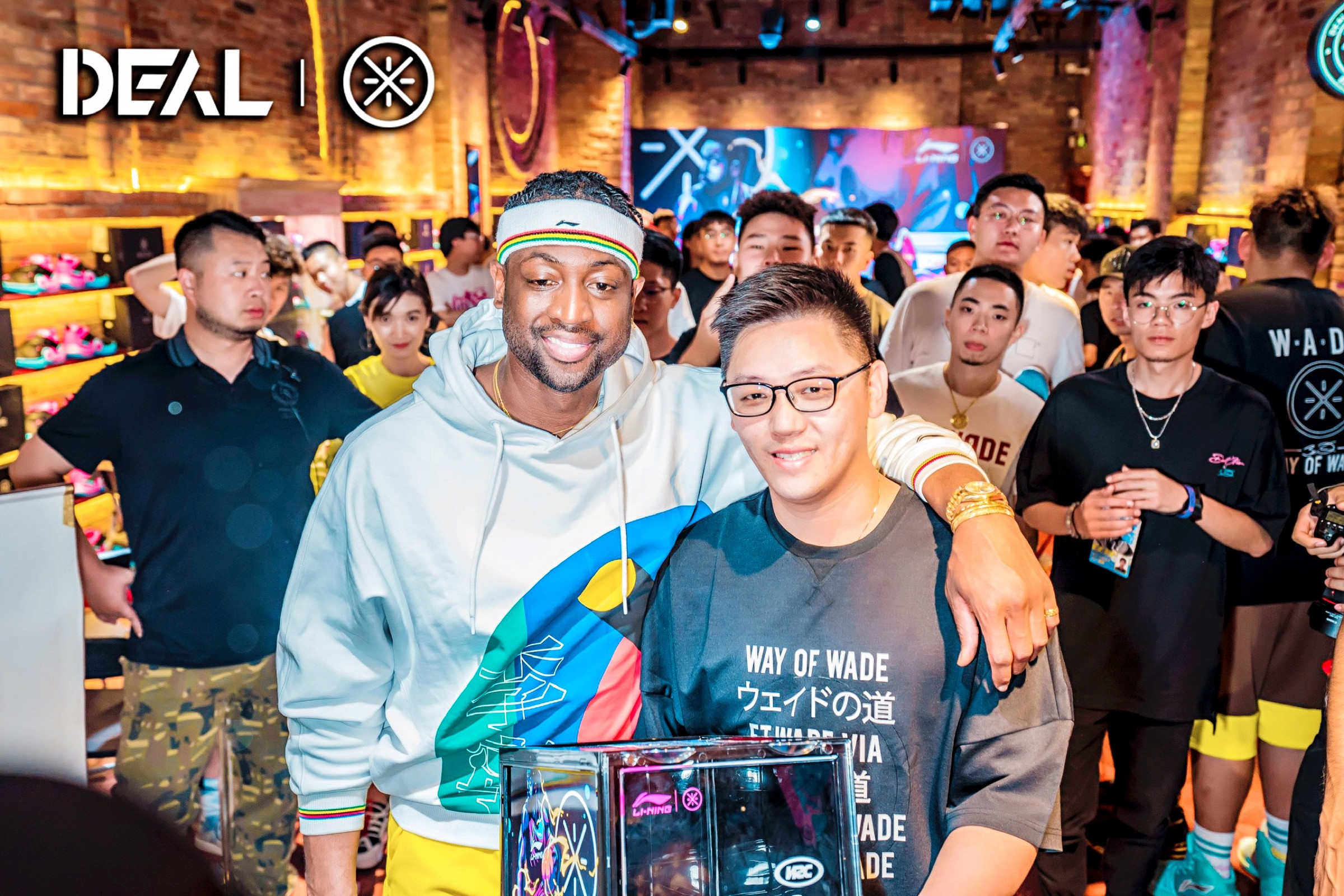 Dwyane Wade holding the SUPBRO and Way of Wade co-branded sneaker display box